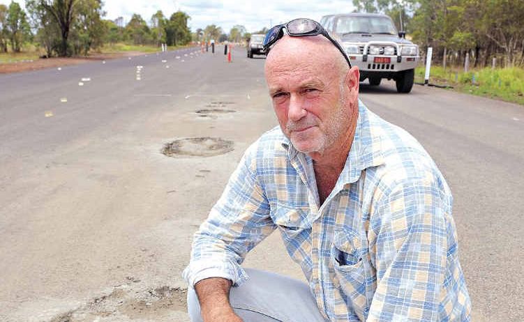 Dave German inspects one of the potholes caused by wet weather. Dave German inspects one of the potholes caused by wet weather.